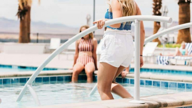 woman entering private pool at a St. George vacation rental