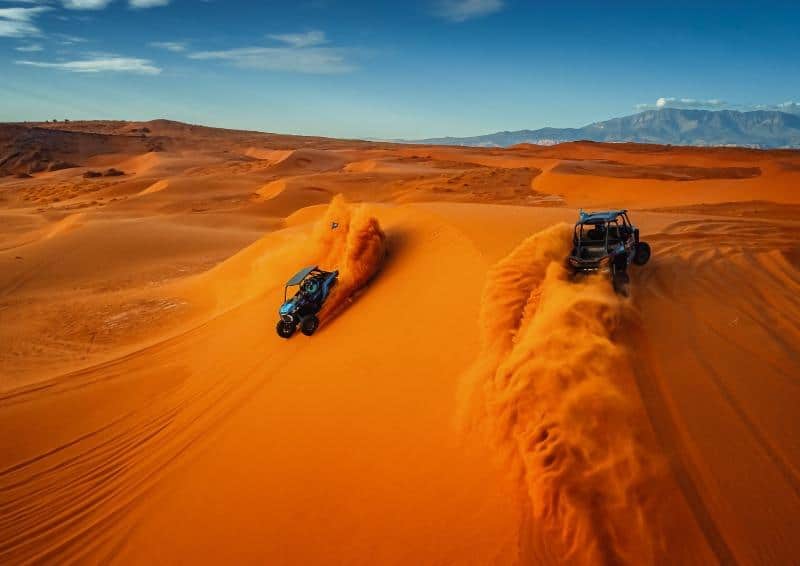 ATVs riding on sand dunes