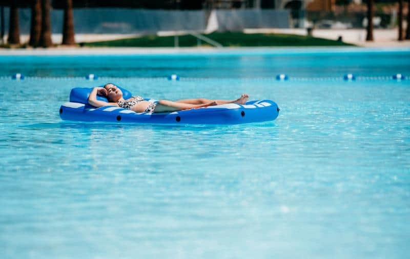 woman floating on a pool float at a St. George vacation rental