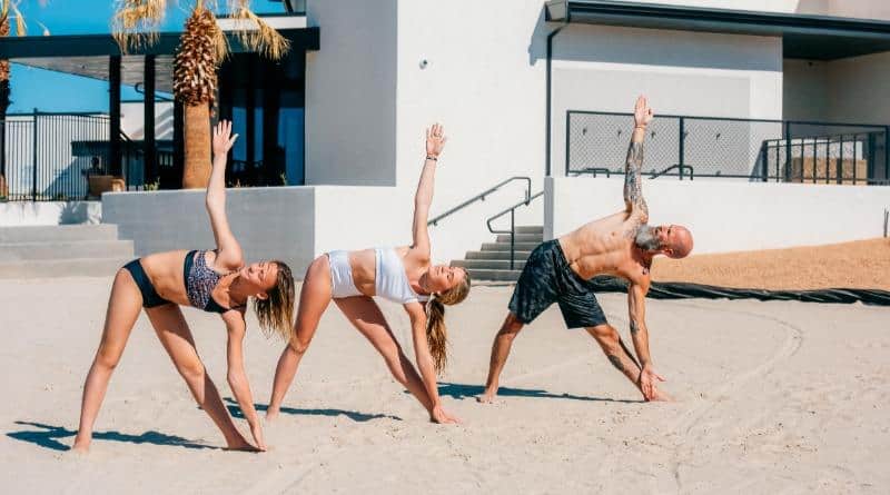 three people doing yoga outside a St. George vacation rental